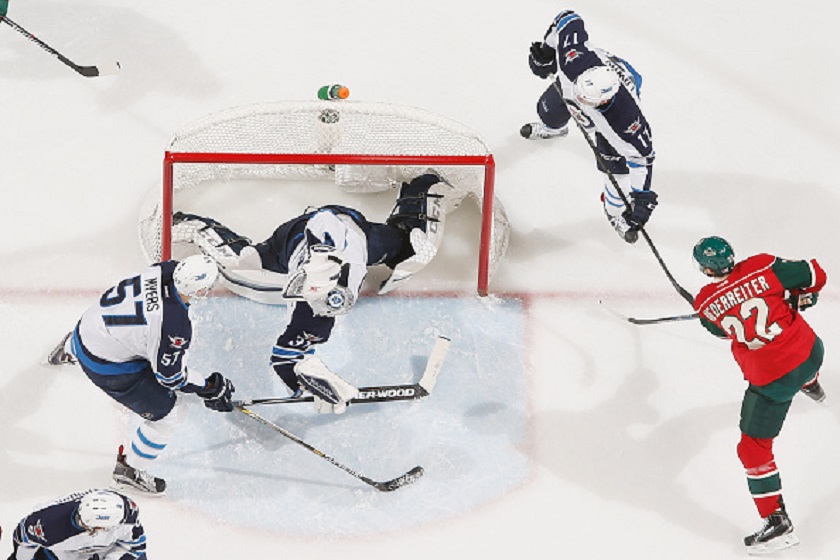 Nino Niederreiter #22 of the Minnesota Wild scores a goal with (L-R) Tyler Myers #57, Ondrej Pavelec #31, and Adam Lowry #17 of the Winnipeg Jets defending during the game on November 10, 2015 at the Xcel Energy Center in St. Paul, Minnesota. 