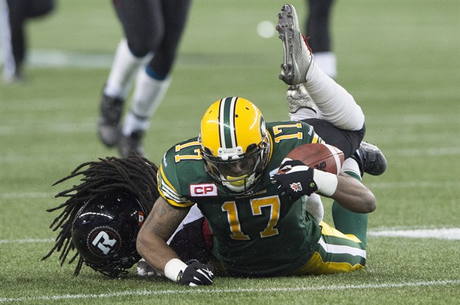 Former Edmonton Eskimos receiver Shamawd Chambers gets tackled by Ottawa Redblacks' Abdul Kanneh during the 103rd Grey Cup in Winnipeg, Man. Sunday, Nov. 29, 2015.  On Feb. 9, 2016, Chambers signed with the Saskatchewan Roughriders.