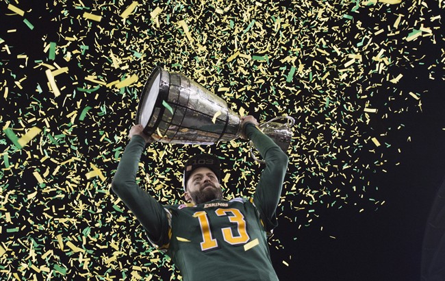Edmonton Eskimos quarterback Mike Reilly hoists the Grey Cup after his teams win over the Ottawa Redblacks during the 103rd Grey Cup in Winnipeg, Man., Sunday, Nov. 29, 2015. 