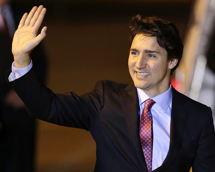 Prime Minister Justin Trudeau waves to media upon his arrival to attend the Asia Pacific Economic Cooperation Summit at the international airport of Manila, Philippines.  