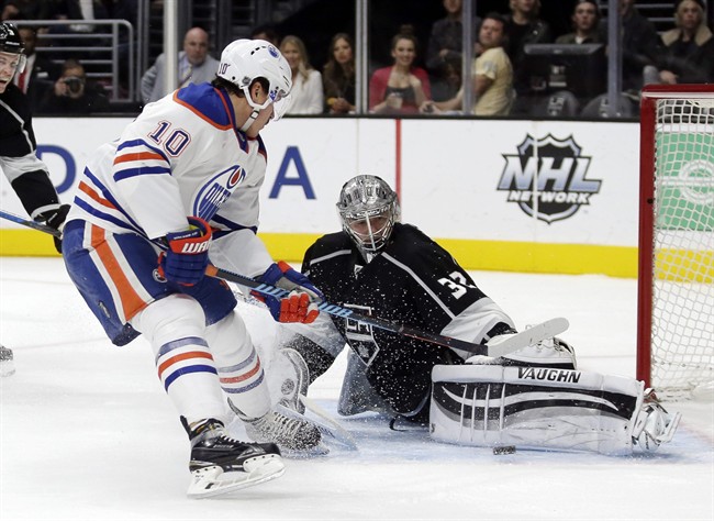 Los Angeles Kings goalie Jonathan Quick, right, blocks a shot by Edmonton Oilers right wing Nail Yakupov, left, during the first period of an NHL hockey game in Los Angeles, Saturday, Nov. 14, 2015. 