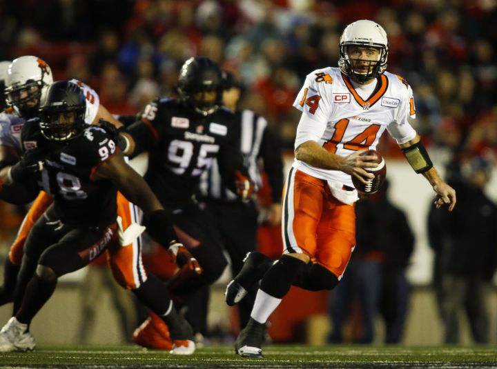 BC Lions quarterback Travis Lulay, right, runs the ball against the Calgary Stampeders' during second half CFL western semifinal football action in Calgary, Sunday, Nov. 15, 2015.
