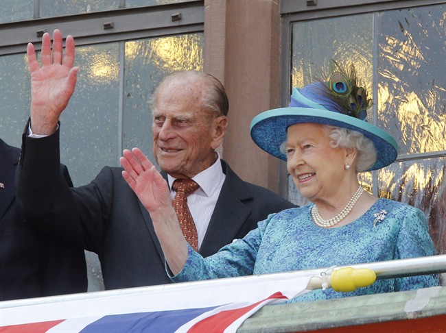 This is a Thursday, June 25, 2015 file photo of Britain’s Queen Elizabeth II and her husband Prince Philip, as they wave from the balcony of the Roemer town hall in Frankfurt, Germany.