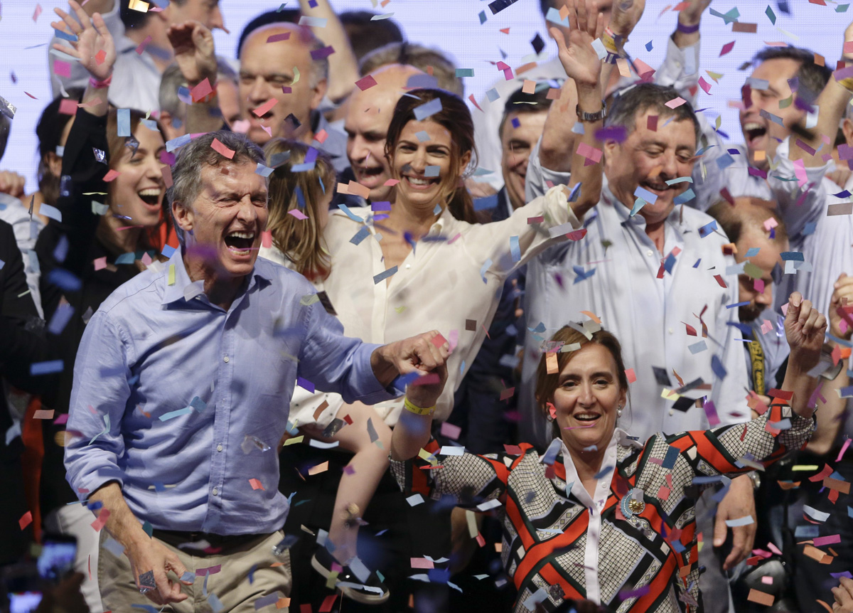 Opposition presidential candidate Mauricio Macri, left, and running mate Gabriela Michetti celebrate after winning a runoff presidential election in Buenos Aires, Argentina, Sunday, Nov. 22, 2015. 