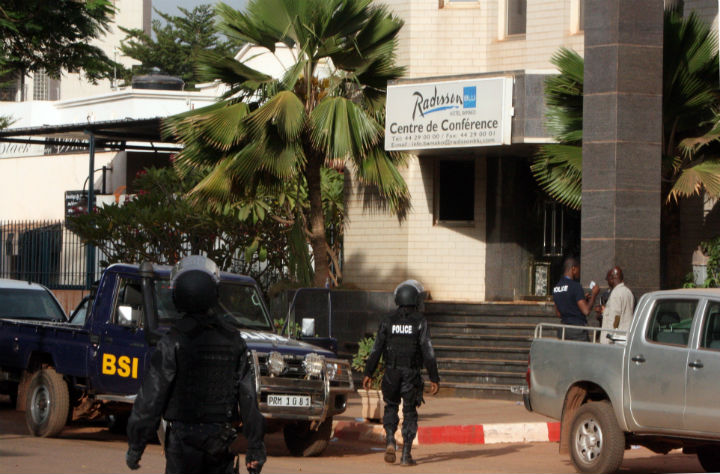 Mali police walk outside one of the entrances to the Radisson Blu hotel's conference center after an attack by gunmen on the hotel in Bamako, Mali, Friday, Nov. 20, 2015.