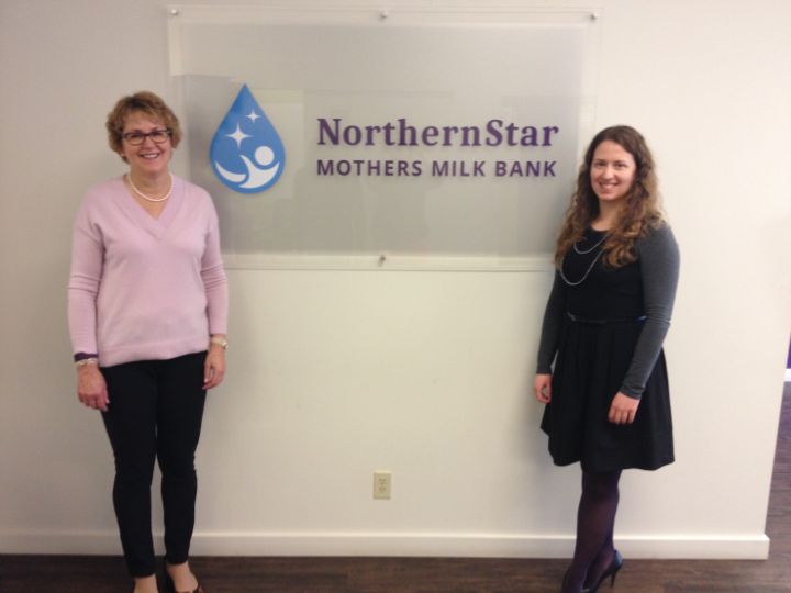 NorthernStar Mothers' Milk Bank Executive Director, Jannette Festival and Clinical Coordinator Megan Hallam stand beside the facility's new logo.