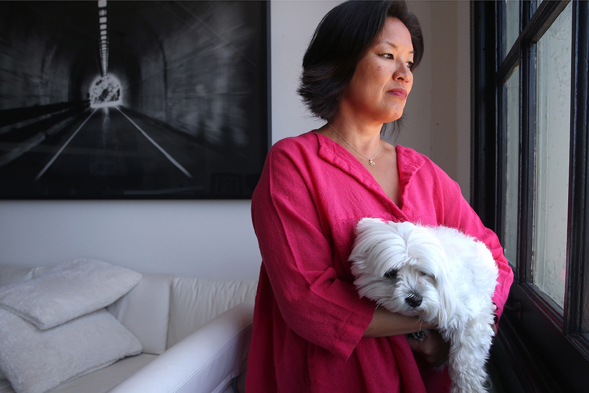  In this June 26, 2015, file photo, Mimi Lee holds her dog Toshi at her loft in San Francisco. 