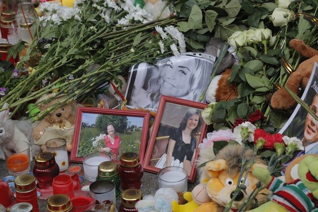 Portraits of plane crash victims are placed near flowers and toys at an entrance of Pulkovo airport outside St. Petersburg, Russia, Wednesday, Nov. 4, 2015. A Russian official says families have identified the bodies of 33 victims killed in Saturday's plane crash over Egypt. The Russian jet crashed over the Sinai Peninsula early Saturday, killing all 224 people on board. Most of them were holidaymakers from Russia's St. Petersburg. (AP Photo/Dmitry Lovetsky).