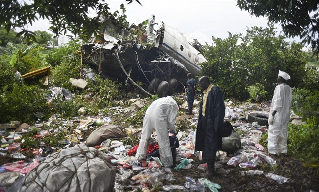 Responders pick through the wreckage of a cargo plane which crashed in the capital Juba, South Sudan Wednesday, Nov. 4, 2015. The cargo plane was taking off from the South Sudanese capital of Juba when it crashed along the banks of the Nile River, killing dozens according to witnesses and the government. (AP Photo/Jason Patinkin).