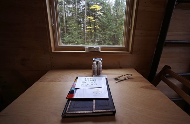 In this Tuesday, Oct. 20, 2015 photo, a guest register and information regarding property rentals are seen on a kitchen table at a tiny house in Croydon, N.H. 