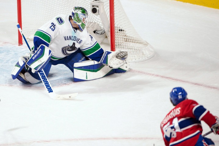 Montreal Canadiens center David Desharnais (51) scores the winning goal on Vancouver Canucks goalie Jacob Markstrom (25) during the overtime period against the Vancouver Canucks in National Hockey League action Monday, November 16, 2015 in Montreal. 