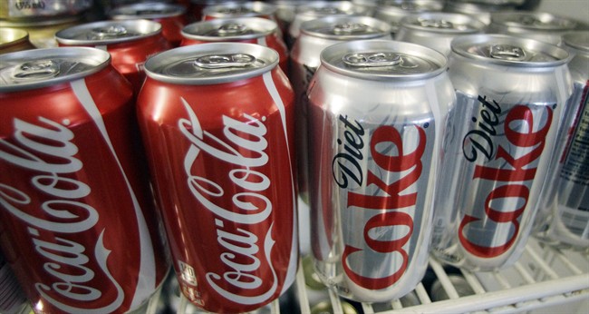 In this March 17, 2011, file photo, Cans of Coca-Cola and Diet Coke sit in a cooler in Anne's Deli in Portland, Ore.