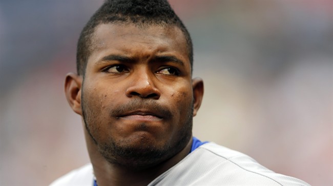 This July 20, 2015, file photo shows Los Angeles Dodgers right fielder Yasiel Puig looking on from the dugout during a baseball game against the Atlanta Braves in Atlanta. 