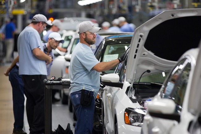 In this July 31, 2012 file photo, employees work on vehicles at the Volkswagen plant in Chattanooga, Tenn. 