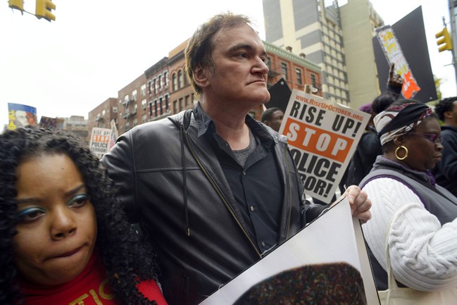 In this Oct. 24, 2015 file photo, director Quentin Tarantino, center, participates in a rally to protest against police brutality in New York.