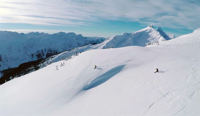 This December 2014 image taken from a drone shows skiers making their ways down a mountainside at resort at Revelstoke, B.C., Canada. Some US ski resorts are exploring the possibility of "drone zones" where professionally operated drones can produce customized video that show off individuals skiers in action.