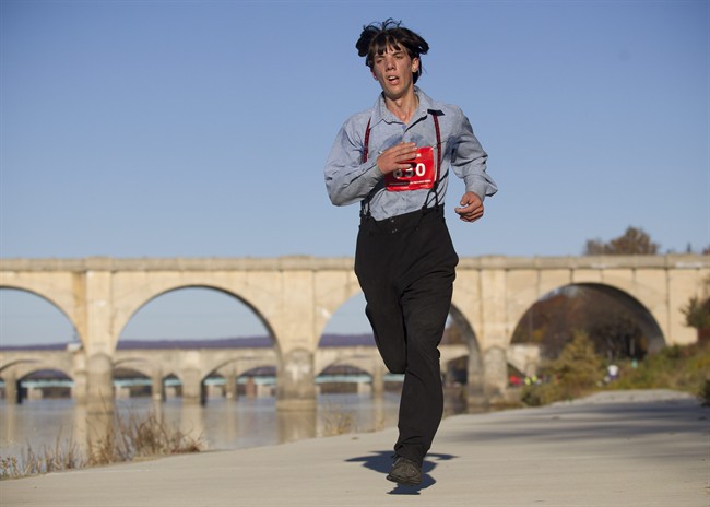 In this photo taken on Sunday, Nov. 8, 2015, Leroy Stolzfus, of Gordonville runs in the 2015 Harrisburg Marathon in Harrisburg, Pa.