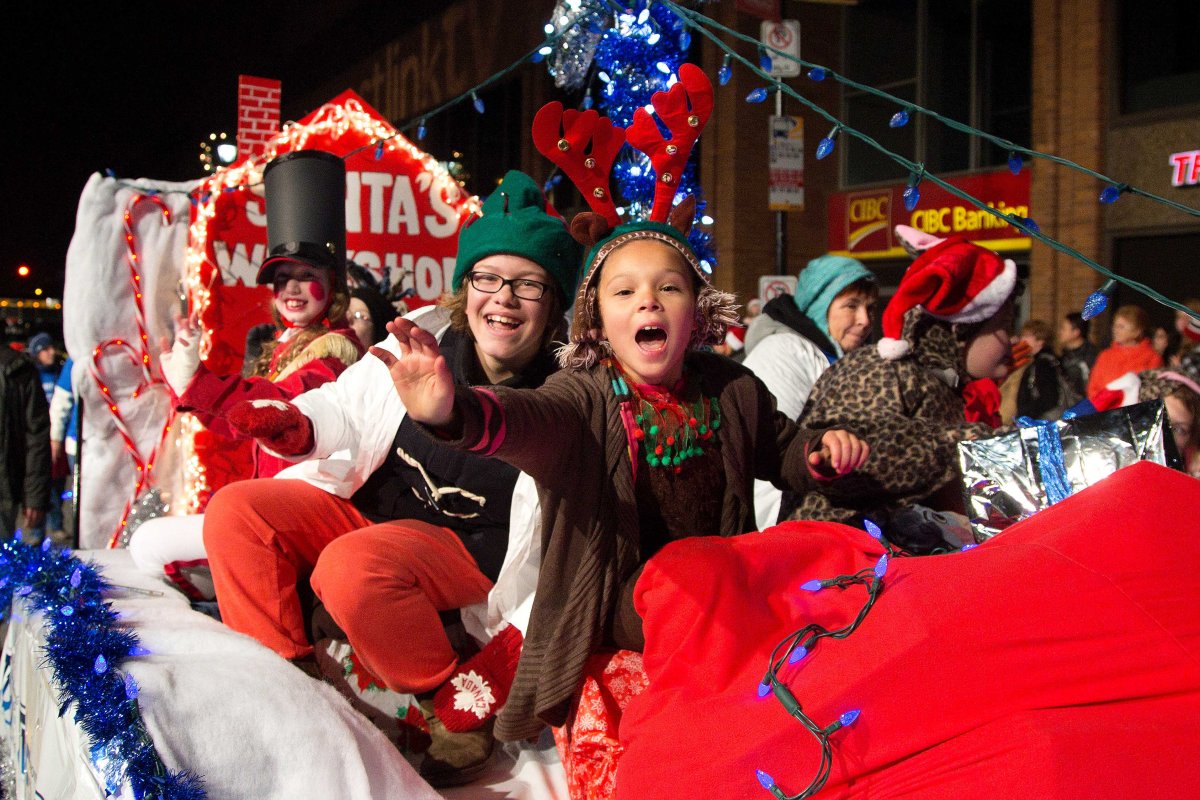 Children wave from a float in the Holiday Parade of Lights. 