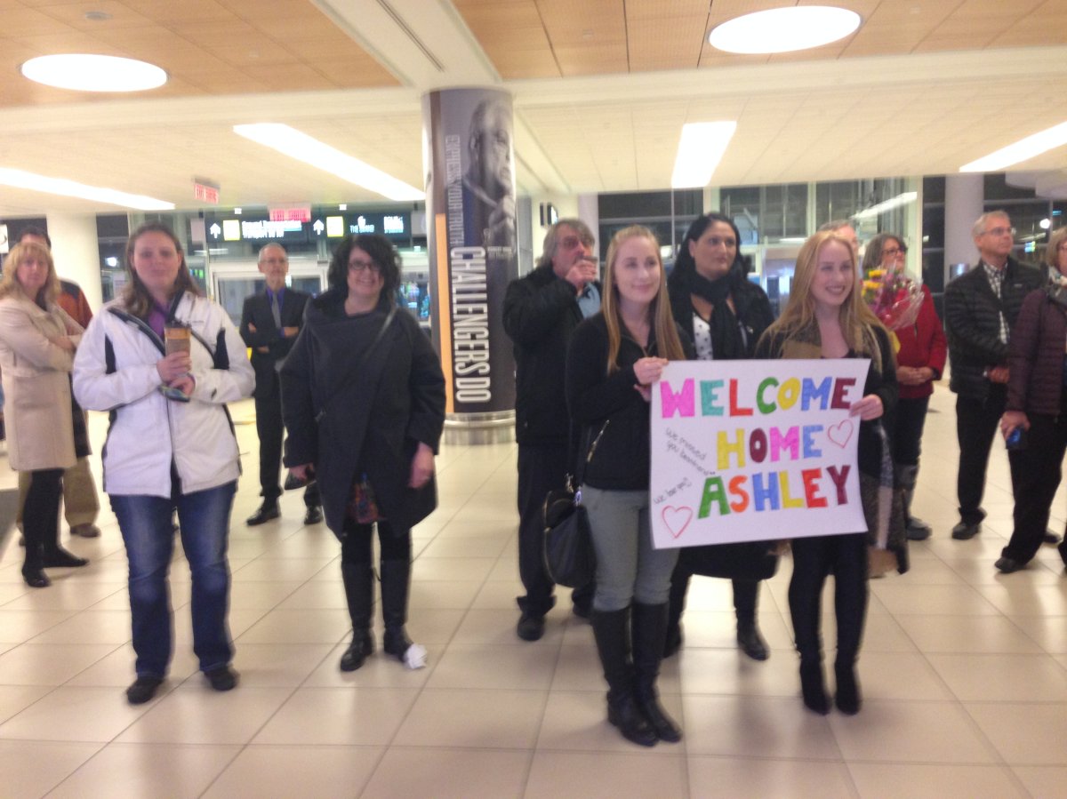 Family and friends wait for seven students to arrive from Paris, France on Monday.