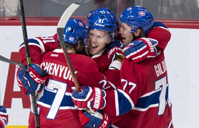 Montreal Canadiens' Lars Eller (81) celebrates his goal against the Boston Bruins with teammates Alex Galchenyuk (27) and Tom Gilbert (77) during third period NHL hockey action, in Montreal, on Saturday, Nov. 7, 2015. The Canadiens beat the Bruins 4-2.