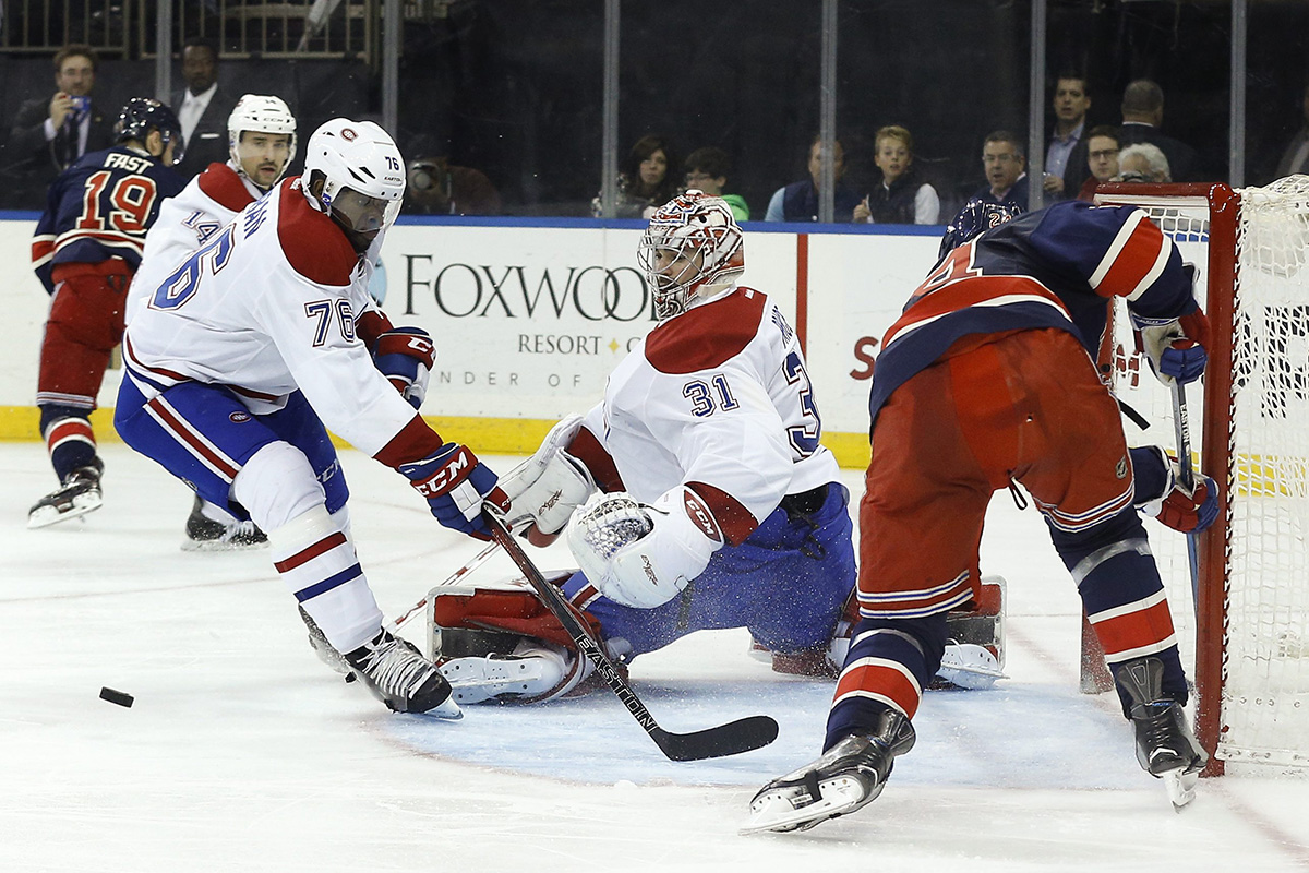 Montreal Canadiens goalie Carey Price (31) blocks a shot attempt by New York Rangers center Oscar Lindberg (24) as Canadiens defenseman P.K. Subban (76) looks for the rebound.
