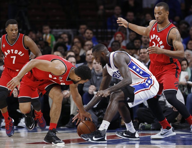 Philadelphia 76ers' JaKarr Sampson, second from right, battles for a loose ball with Toronto Raptors' Cory Joseph, second from left, as Toronto's Kyle Lowry, left, and Norman Powell watch during the first half of an NBA basketball game Wednesday, Nov. 11, 2015, in Philadelphia. (AP Photo/Matt Slocum).