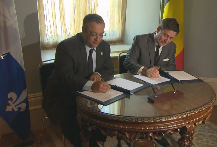 Quebec's Pierre Moreau and Belgium's Rachid Madrane sign a deal to battle radicalism, Tuesday, November 17, 2015.