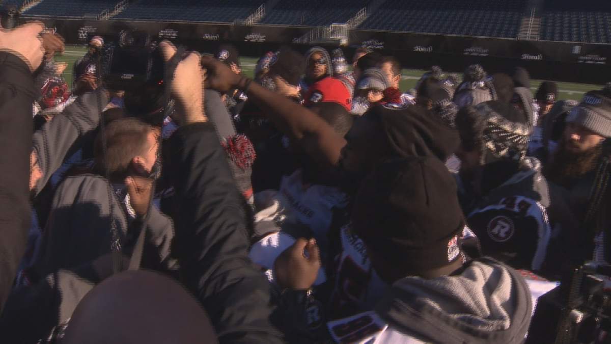 The Ottawa RedBlacks huddle at centre field at Investors Group Field after taking final walk through on Saturday.