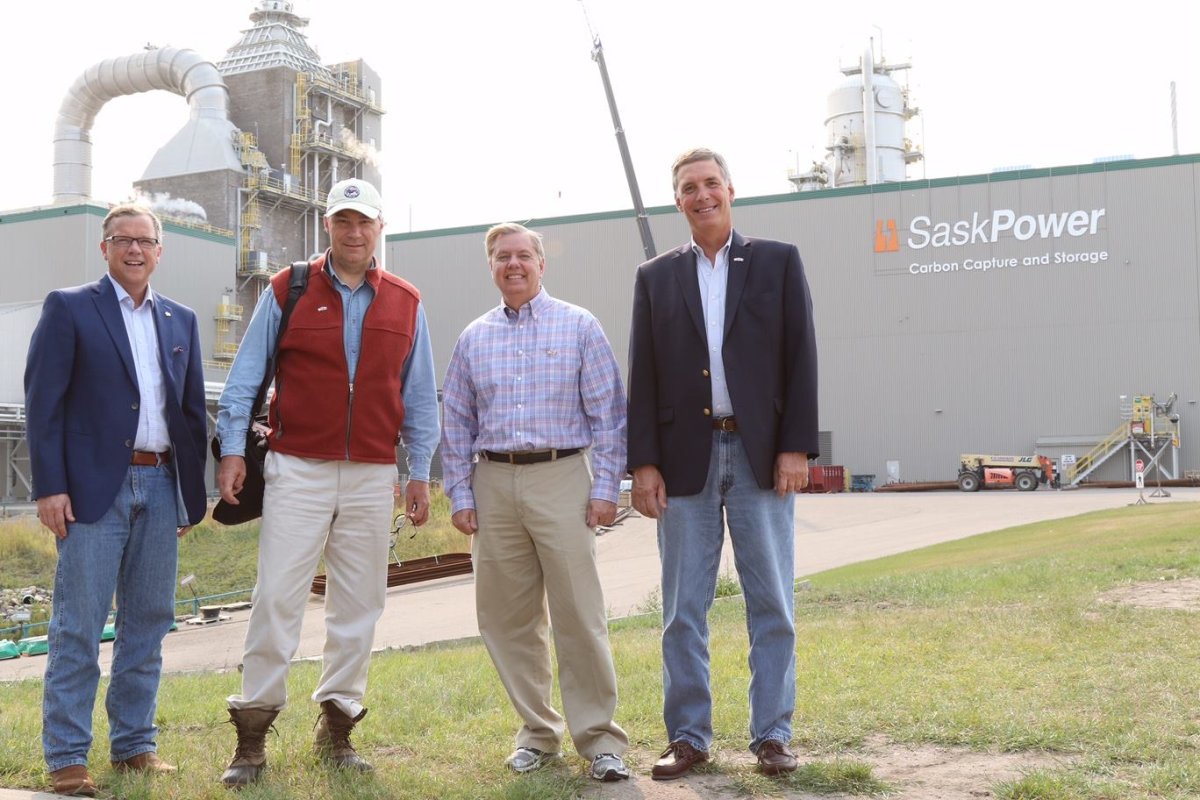 Saskatchewan Premier Brad Wall poses with U.S. senators Shelton Whitehouse and Lindsey Graham and Congressman Tom Rice outside the Boundary Dam carbon capture and storage unit in August 2015.