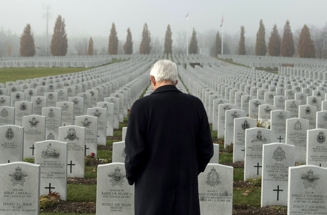 Retired lieutenant-general Richard Evraire walks among tombstones in the National Military Cemetery of the Canadian Forces in Ottawa, a day before Remembrance Day, on Tuesday, Nov. 10, 2015.