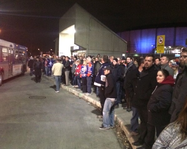 Hockey fans wait for buses outside Rexall Place Wednesday, Nov. 18, 2015 after a portion of the LRT line went down.