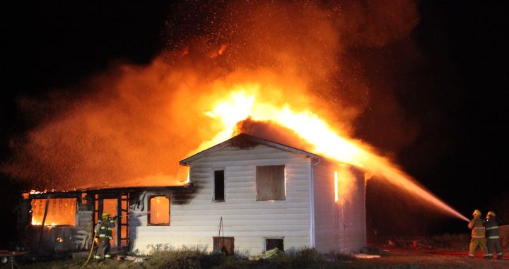 Fire crews battle a house fire in Rimbey, Alberta Tuesday, Nov. 10, 2015.