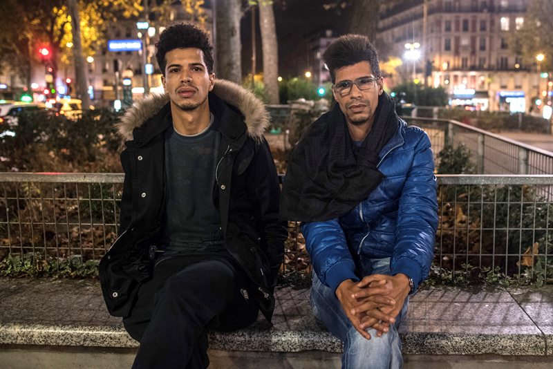 In this photo taken on Sunday, Nov. 15, 2015, Khaled Saadi, 27, left and Abdullah Saadi, 38, listen during an interview with the Associated Press.