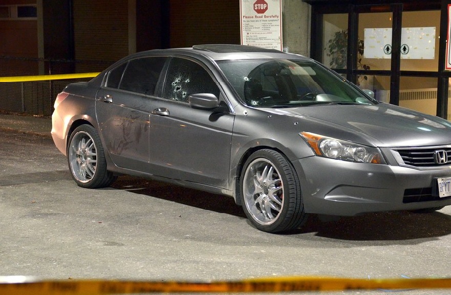 A car is riddled with bullet holes following a shooting in west-end Toronto on Nov. 30, 2015.