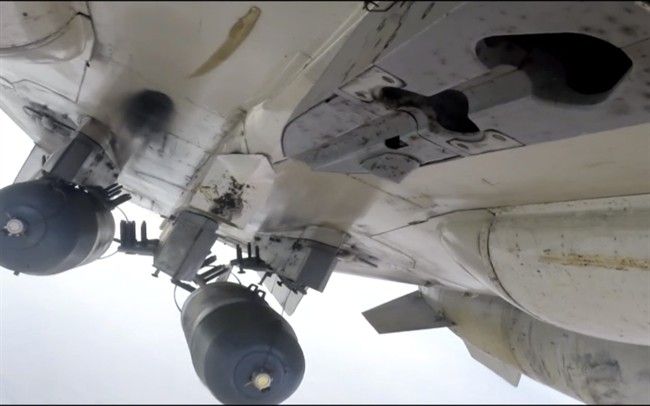 This photo made from footage taken from Russian Defense Ministry official website Tuesday, Nov. 17, 2015, shows a Russian Su-24M during a Russian air raid in Syria. 