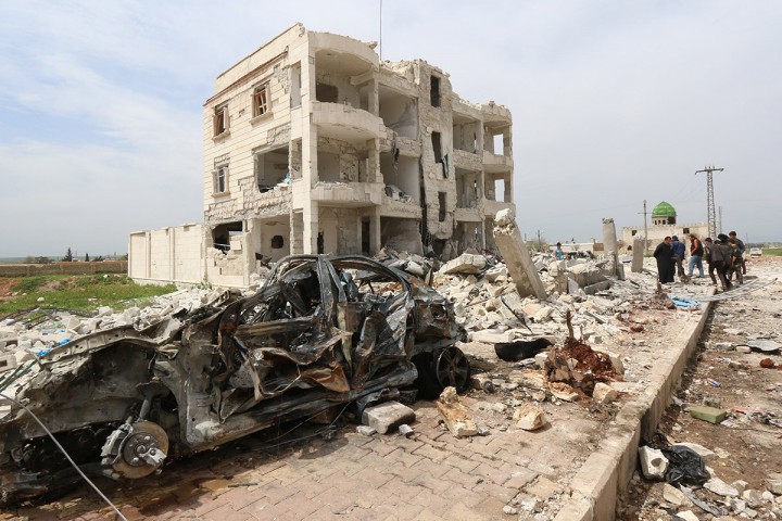 Syrians walk through the rubble following an alleged bombing by Islamic State (IS) group in Marea, northern Aleppo on April 8, 2015. The toll from two alleged Islamic State group car bombings overnight of rebels in Syria's Aleppo province has risen to at least 32 people, the Britain-based Observatory said. 