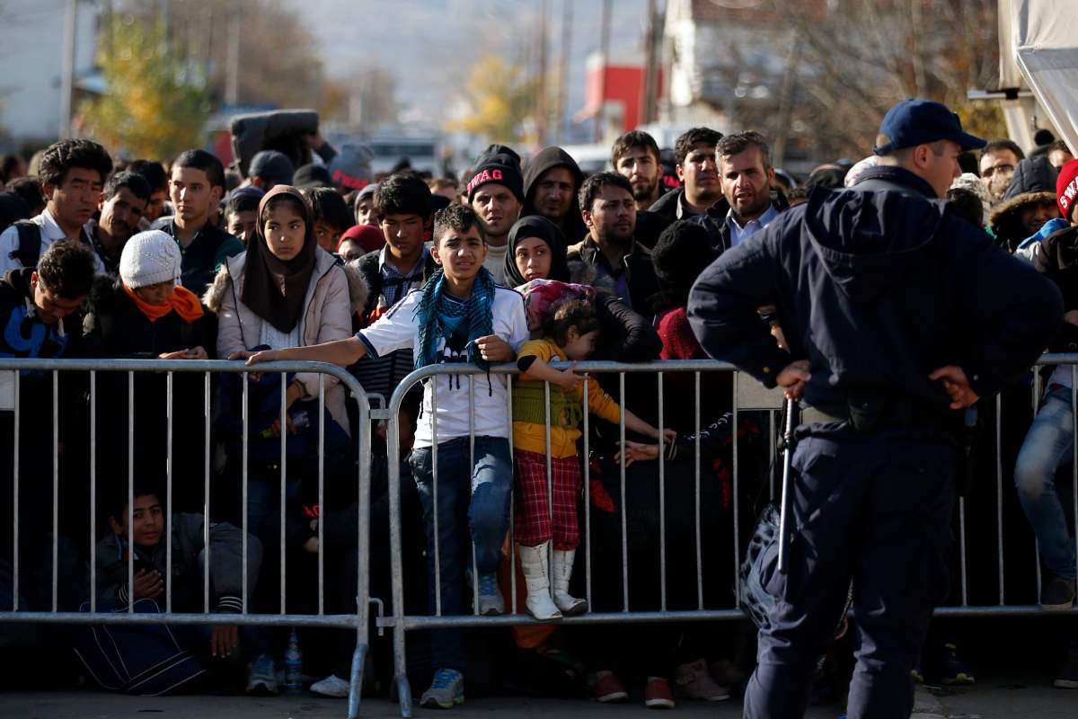 Migrants wait to register with the police at the refugee center in the southern Serbian town of Presevo, Monday, Nov. 16, 2015. 