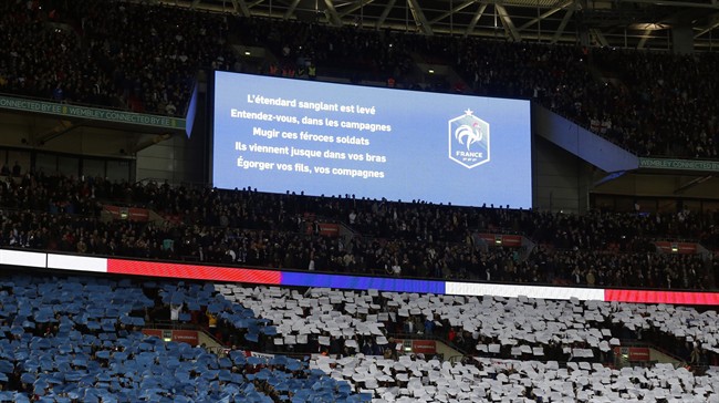 Words from the French national anthem are displayed on a big screen before the international friendly soccer match between England and France at Wembley Stadium in London, Tuesday, Nov. 17, 2015.