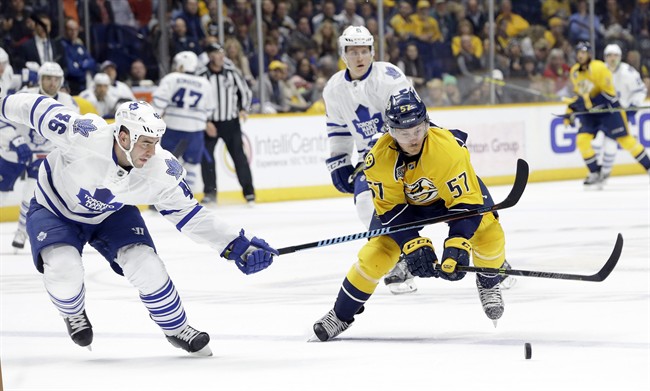 Toronto Maple Leafs defenseman Roman Polak (46) and Nashville Predators left wing Gabriel Bourque (57) chase the puck in the second period of an NHL hockey game Thursday, Nov. 12, 2015, in Nashville, Tenn.