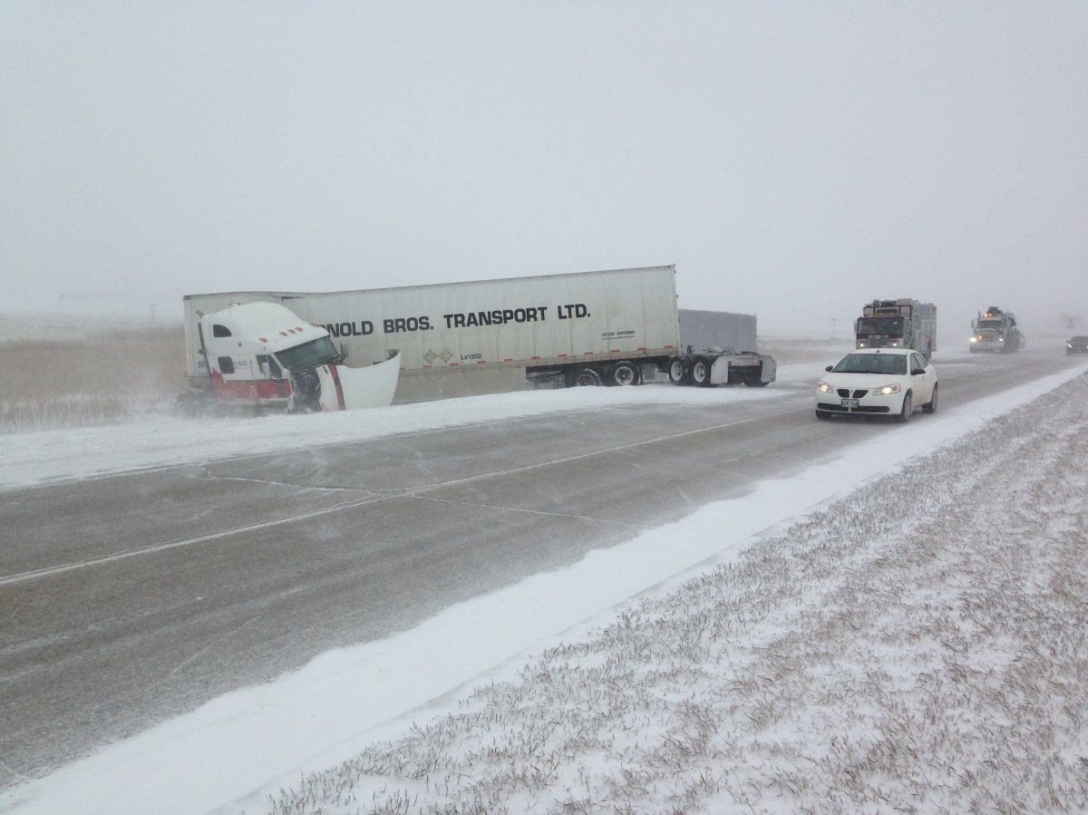 Damaged semi remains on scene following a multi vehicle crash on the west perimeter near Wilkes .
