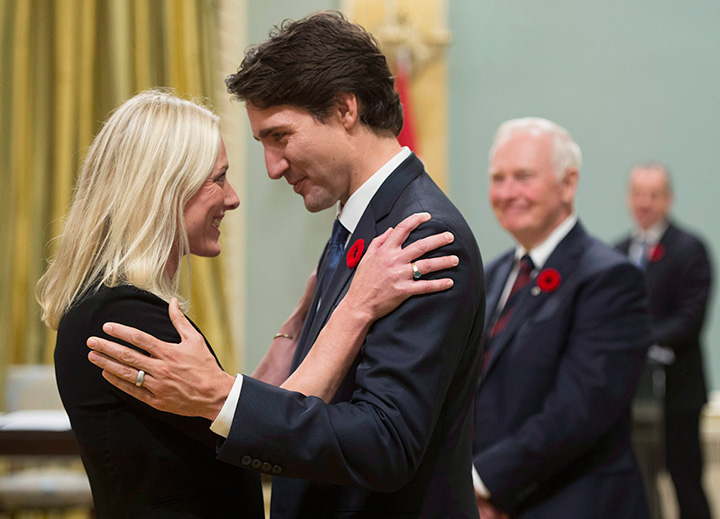 Prime Minister Justin Trudeau hugs Environment and Climate Change Minister Catherine McKenna at Rideau Hall in Ottawa on Wednesday, November 4, 2015.