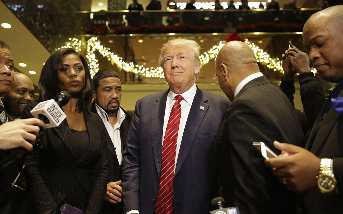 Republican Presidential candidate Donald Trump, center, joins a group of African-American religious leaders to speak to reporters in New York, Monday, Nov. 30, 2015. Trump met with a coalition of 100 African-American evangelical pastors and religious leaders in a private meeting at Trump Tower.
