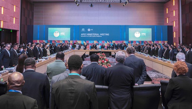 Officials have a moment of silence for those who were involved in deadly attacks in Paris, during the Asia-Pacific Economic Cooperation (APEC) Ministerial Meeting in Manila, Philippines, Monday, Nov. 16, 2015. (Lui Wai Siu/Pool Photo via AP).
