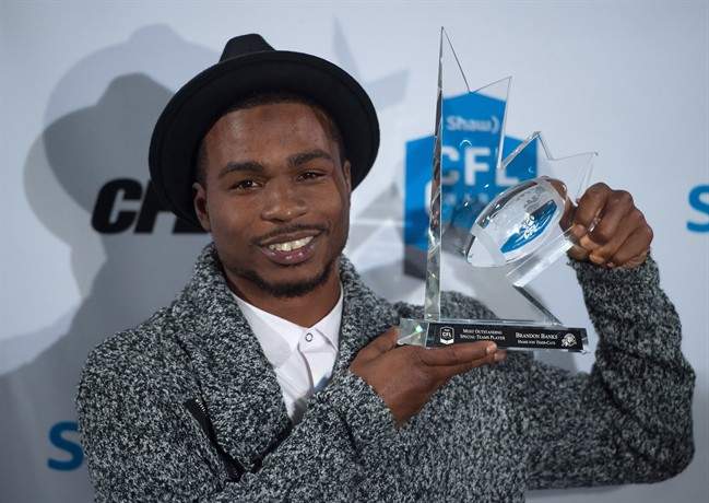 Hamilton Tiger-Cats kick returner Brandon Banks poses for photographs after winning the CFL's most outstanding special teams player award during the Canadian Football League awards in Winnipeg on Thursday November 26, 2015. THE CANADIAN PRESS/Jonathan Hayward.