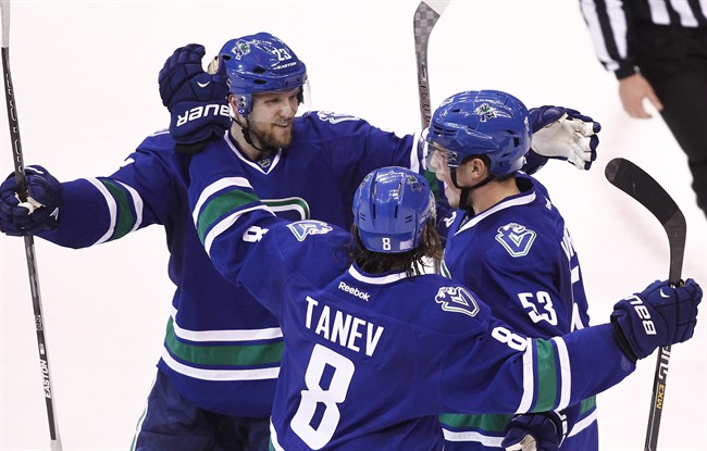 Vancouver Canucks Bo Horvat (53) celebrates his goal against the Philadelphia Flyers with teammates Chris Tanev (8) and Alex Edler (23) during second period NHL hockey action in Vancouver, B.C., on Monday, November 2, 2015. 