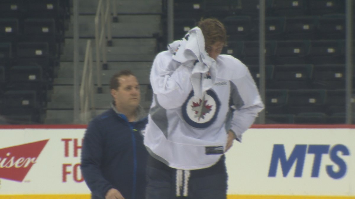 Blake Wheeler leaves the ice after getting hit by a puck during Friday's practice.