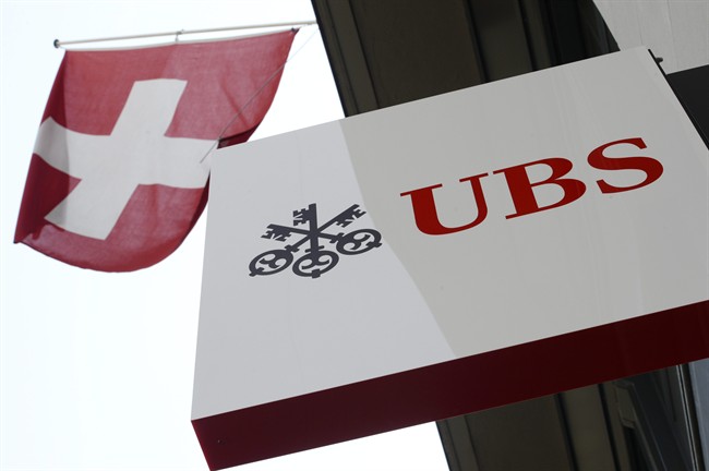 FILE - The April 24, 2014 file photo shows the logo of Swiss bank UBS and the Swiss flag in Zurich, Switzerland. 