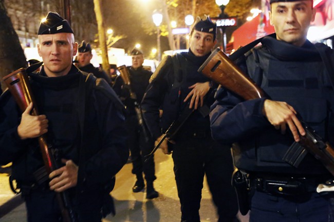 French police patrol at the place de la Republique in Paris, France, Sunday Nov. 15, 2015.