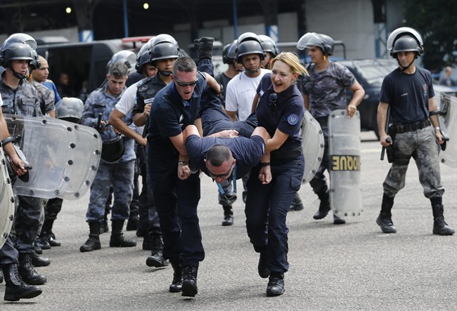 French National Police officers train Brazil's police officers before a drill to prepare security forces for demonstrations and protests during the upcoming Rio 2016 Olympics, in Rio de Janeiro, Brazil, Thursday, Nov. 19, 2015.
