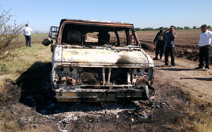 Mexican authorities inspect a burnt out van suspected to belong to a couple of Australian tourists missing for more than a week, in Sinaloa, Mexico. 